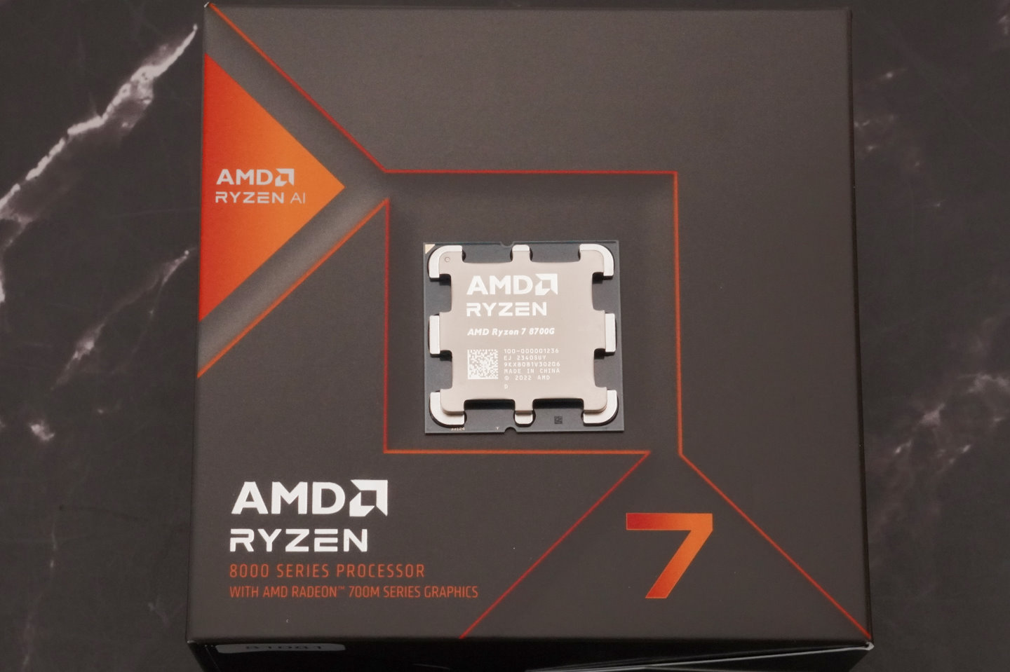 Ryzen 7 8700G本体以及包装盒，可以看到包装上有Ryzen AI的标示。